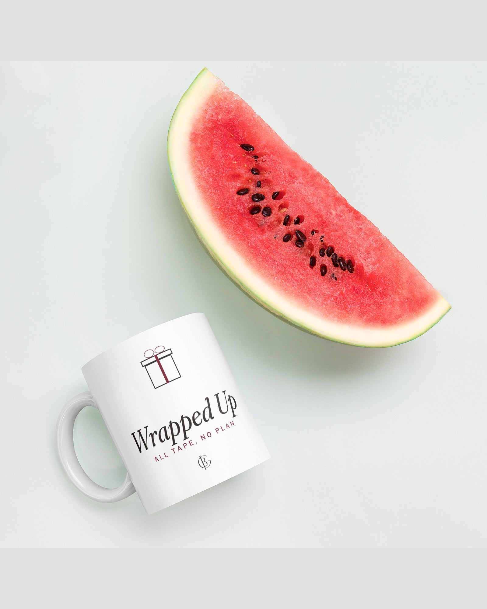 The Wrapped Up Mug in White, styled on a table