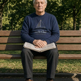 The Yacht Club Crewneck in Navy, older man sitting on a park bench with a newspaper on his lap